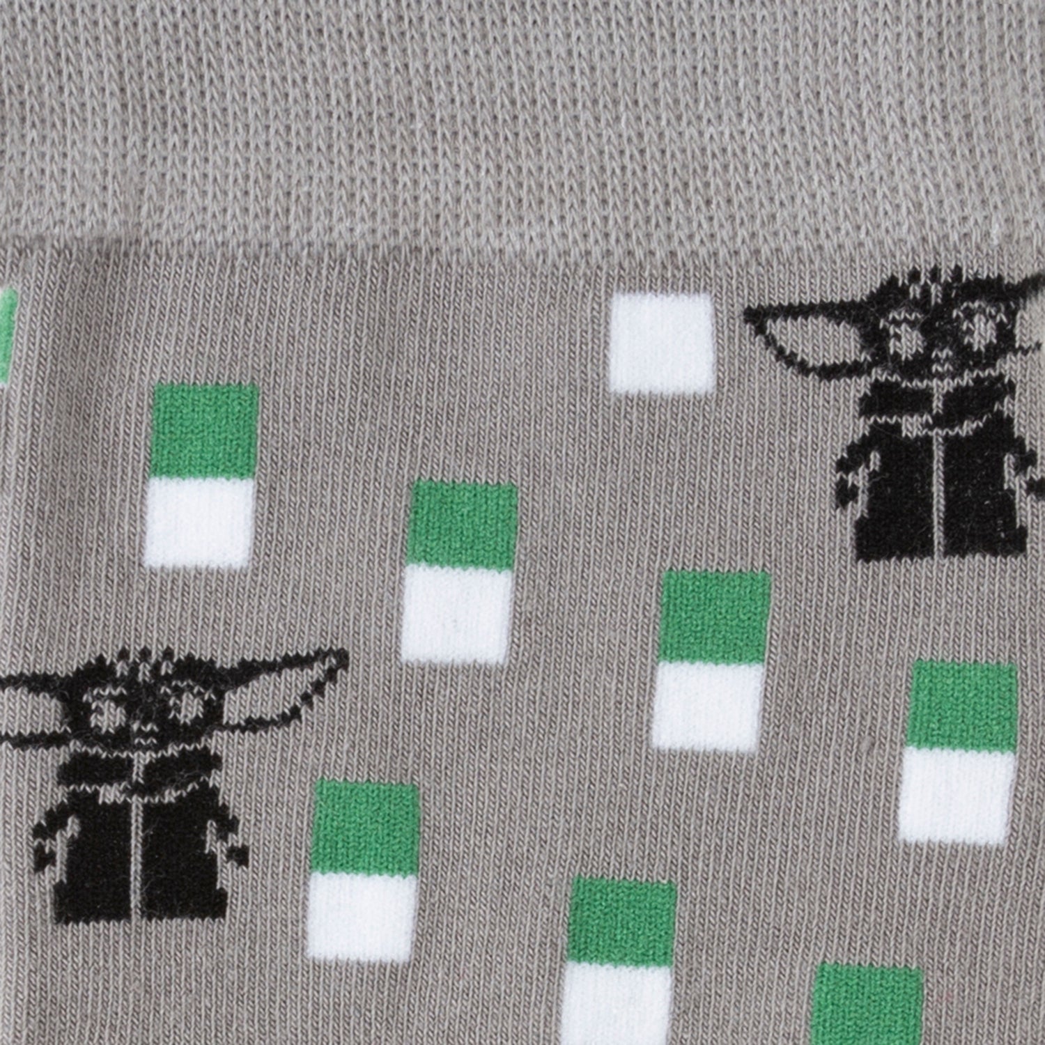 Gray sock with black and green designs of a character and colored squares.