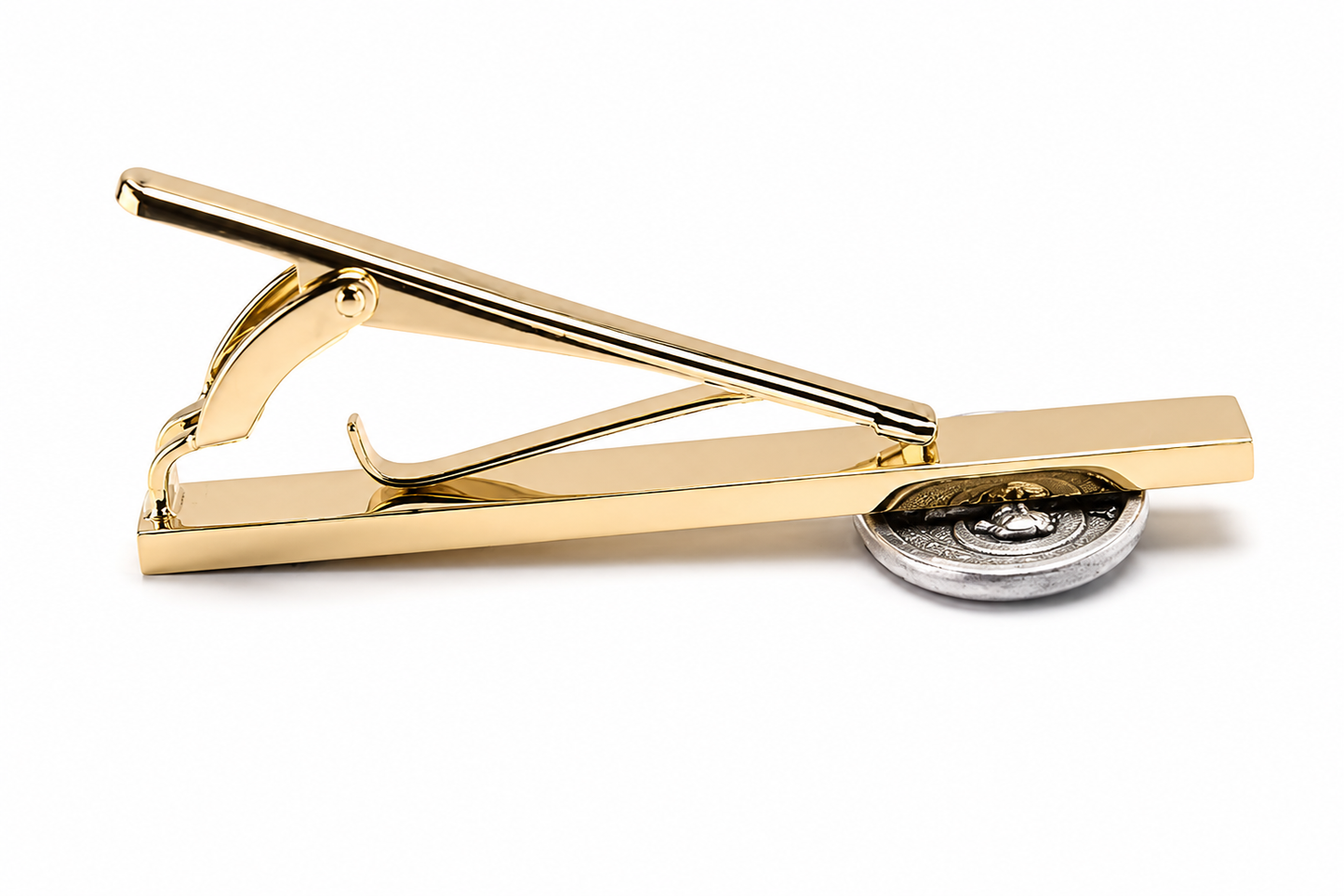A polished gold tie clip with a silver-toned circular decorative element under the lever, shown on a clean white background.