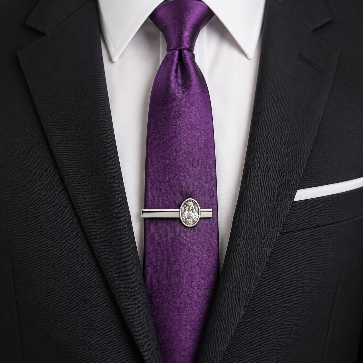 Purple tie with a silver tie clip on a black suit jacket.