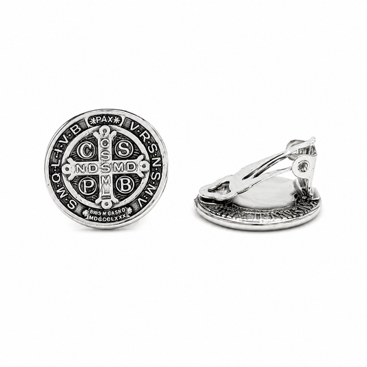 Silver Saint Benedict clip-on earrings featuring detailed Catholic medal design with comfortable non-pierced clip backs on a pure white background.