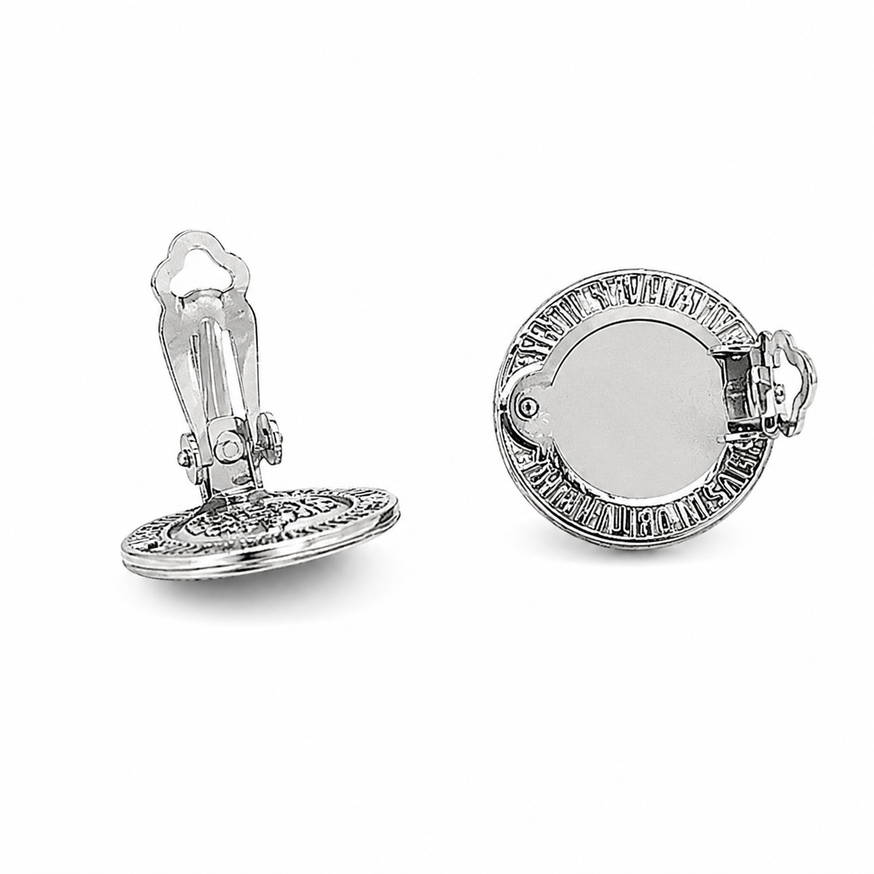 Close-up of silver Saint Benedict medal clip-on earrings with intricate Catholic engraving and polished finish.