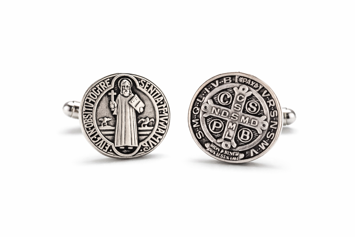 Pair of silver Saint Benedict medallion cufflinks on a white background