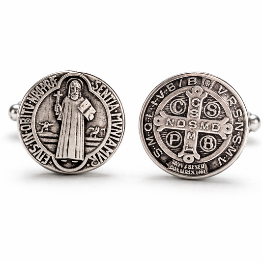 Two silver Saint Benedict medallions on a white background