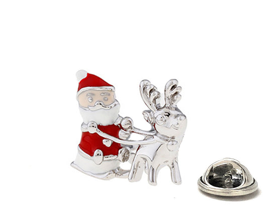 Silver brooch with Santa Claus and reindeer on a white background