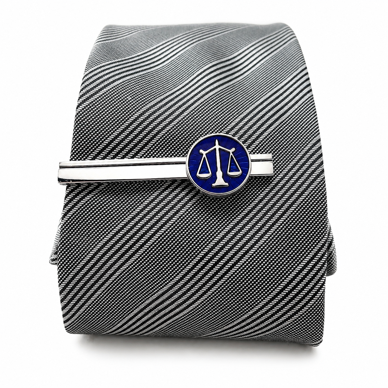 Black and white striped tie with a blue and silver tie clip on a white background
