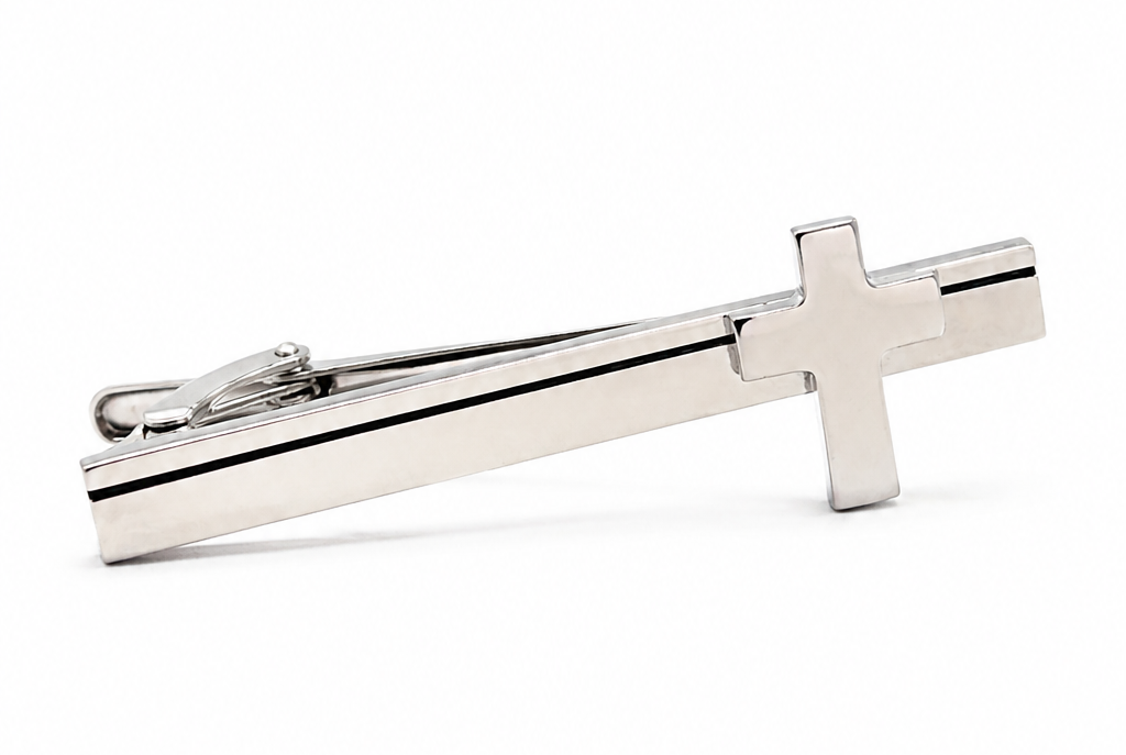 Silver cross-shaped tie clip on a white background
