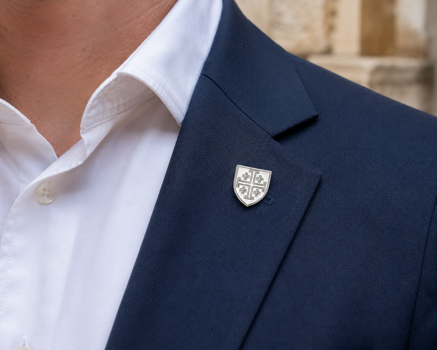 Silver Jerusalem Cross lapel pin onblue suit