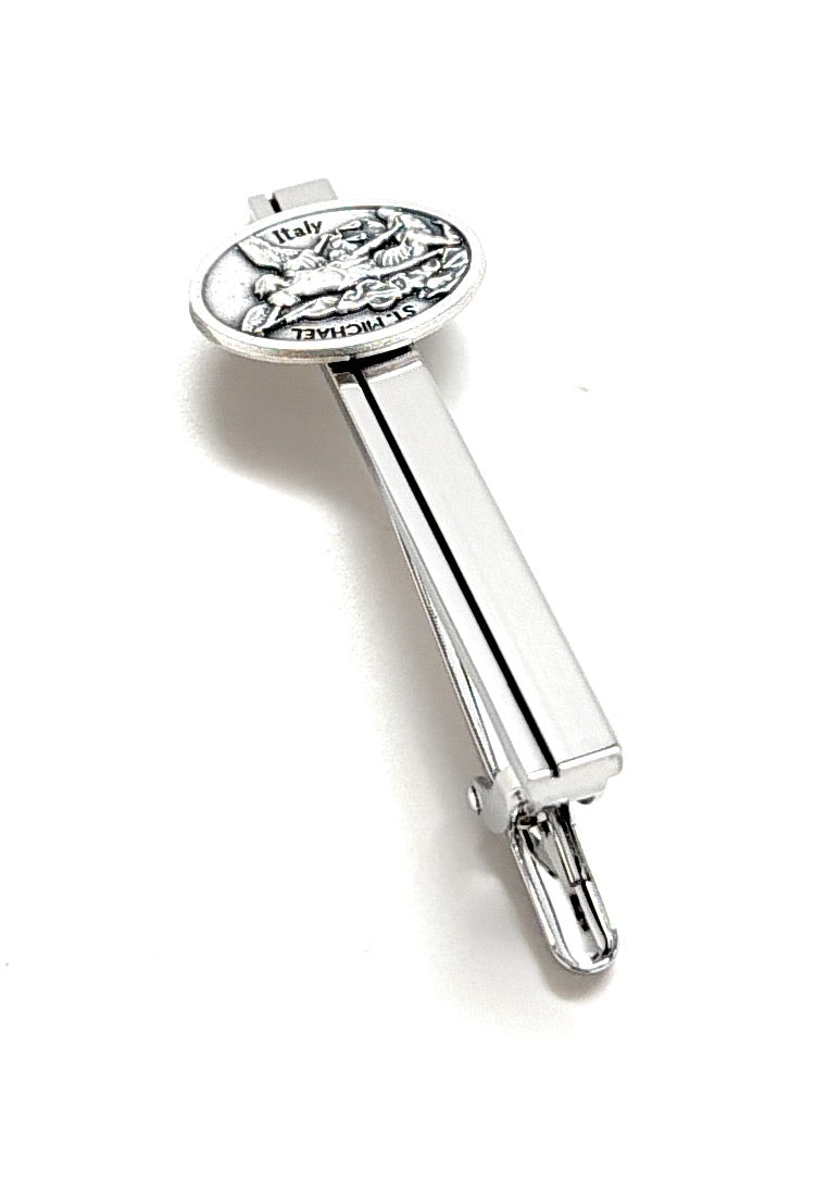 Silver tie clip with engraved design on a white background