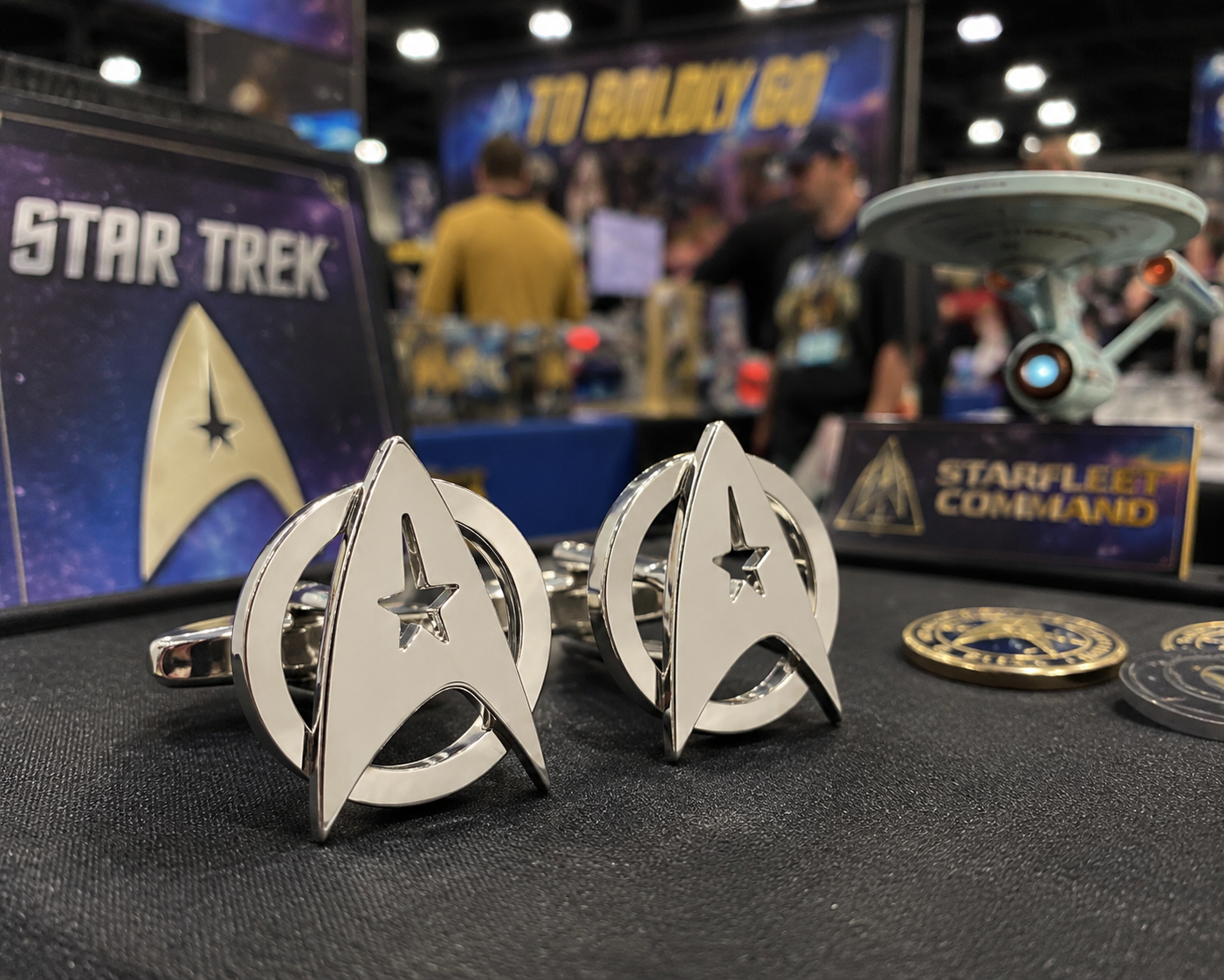 Star Trek-themed cufflinks on display with 'Star Trek' branding in the background.