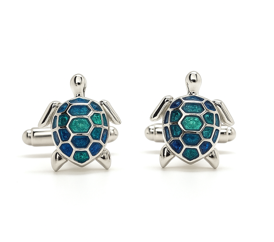 Turtle-shaped cufflinks with blue and green pattern on a white background