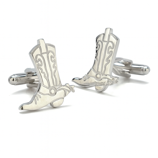 Silver cowboy boot cufflinks on a white background