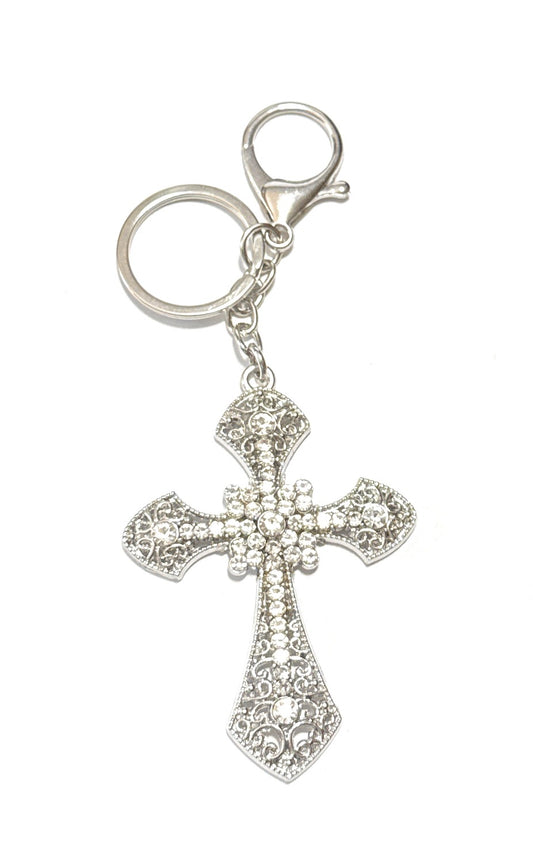 Silver cross keychain with intricate design on a white background