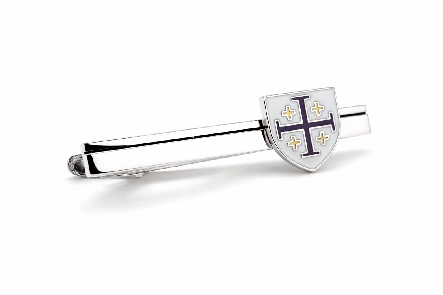 Silver tie clip with a shield design on a white background