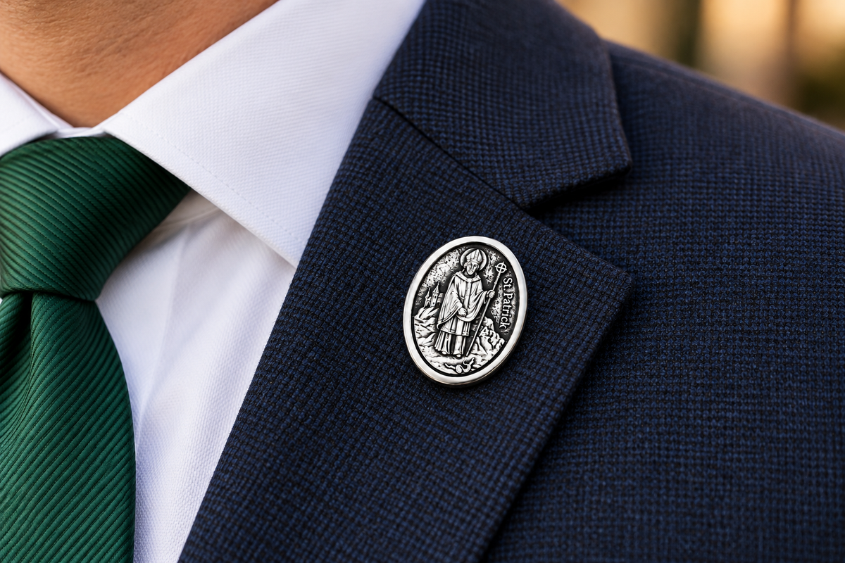 Silver St. Patrick Catholic lapel pin with detailed Saint Patrick medal design and clutch backing blue suit
