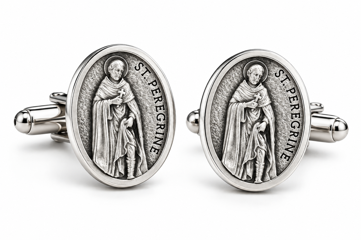 A pair of oval cufflinks featuring a raised silver-toned medallion of Saint Peregrine, with the text 'ST. PEREGRINE' visible around the figure, set against a clean white background.
