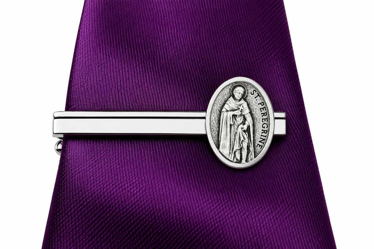 A silver-toned St. Stephen tie clip holding a purple textured necktie, shown against a plain white background.