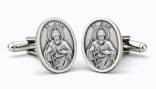 Silver St. Jude-themed cufflinks on a white background