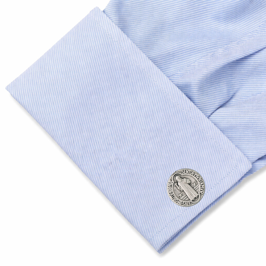 Close-up of a light blue dress shirt with a cufflink on a white background