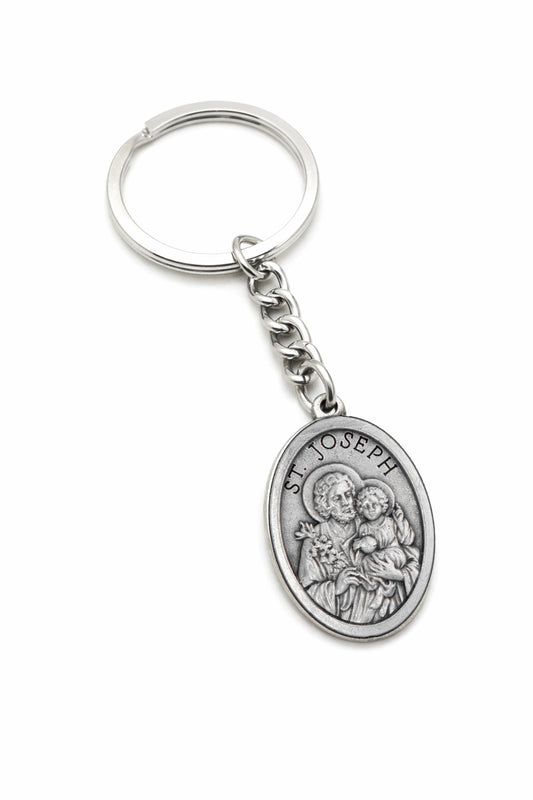 Silver keychain with St. Joseph pendant on a white background