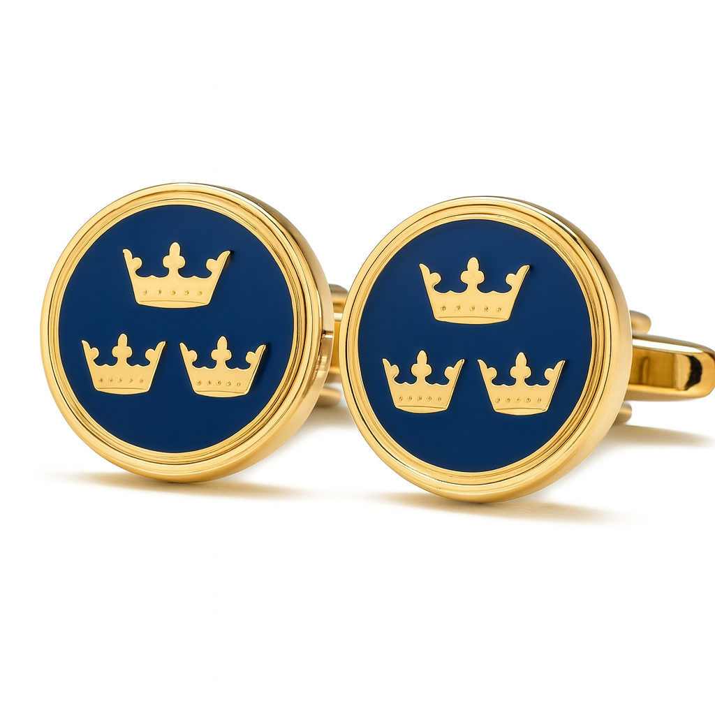 Gold cufflinks with blue background and crown design on a white background