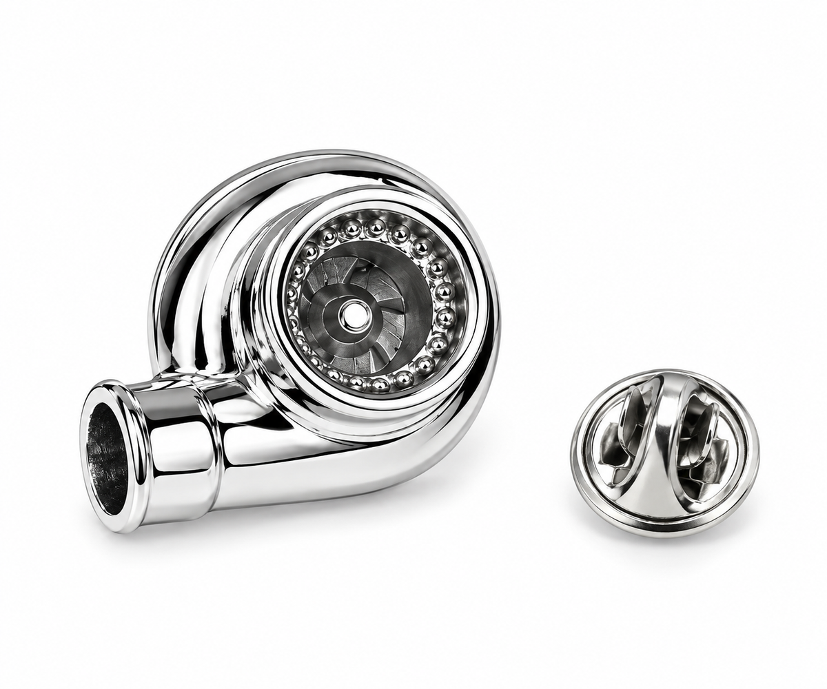 A polished chrome spiral-shaped accessory with a circular inset and a separate matching round cap or cover, shown on a clean white background.