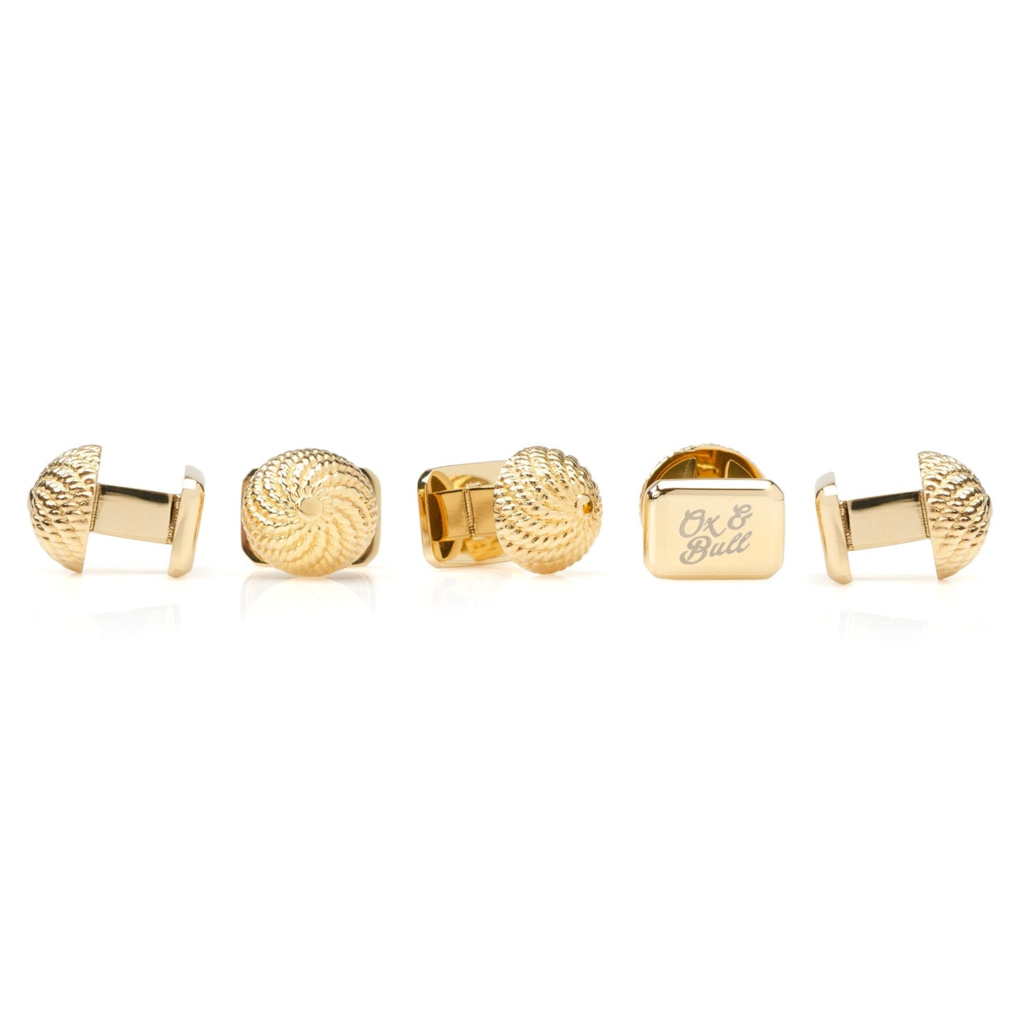 Set of gold cufflinks on a white background
