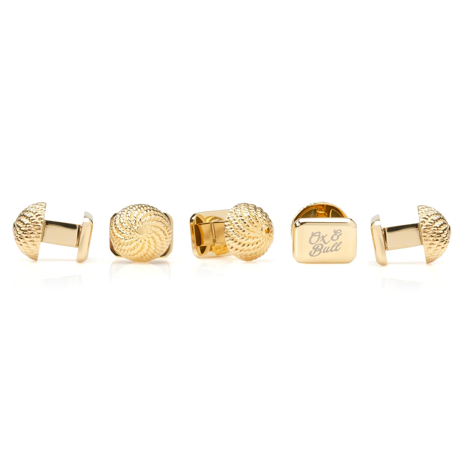 Set of gold cufflinks on a white background