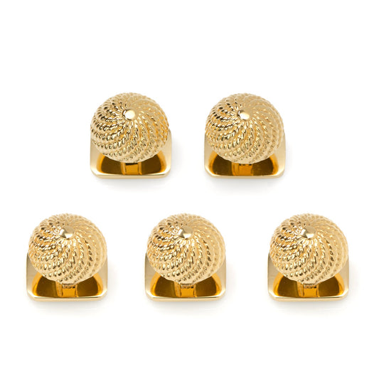 Set of five gold decorative knobs on a white background
