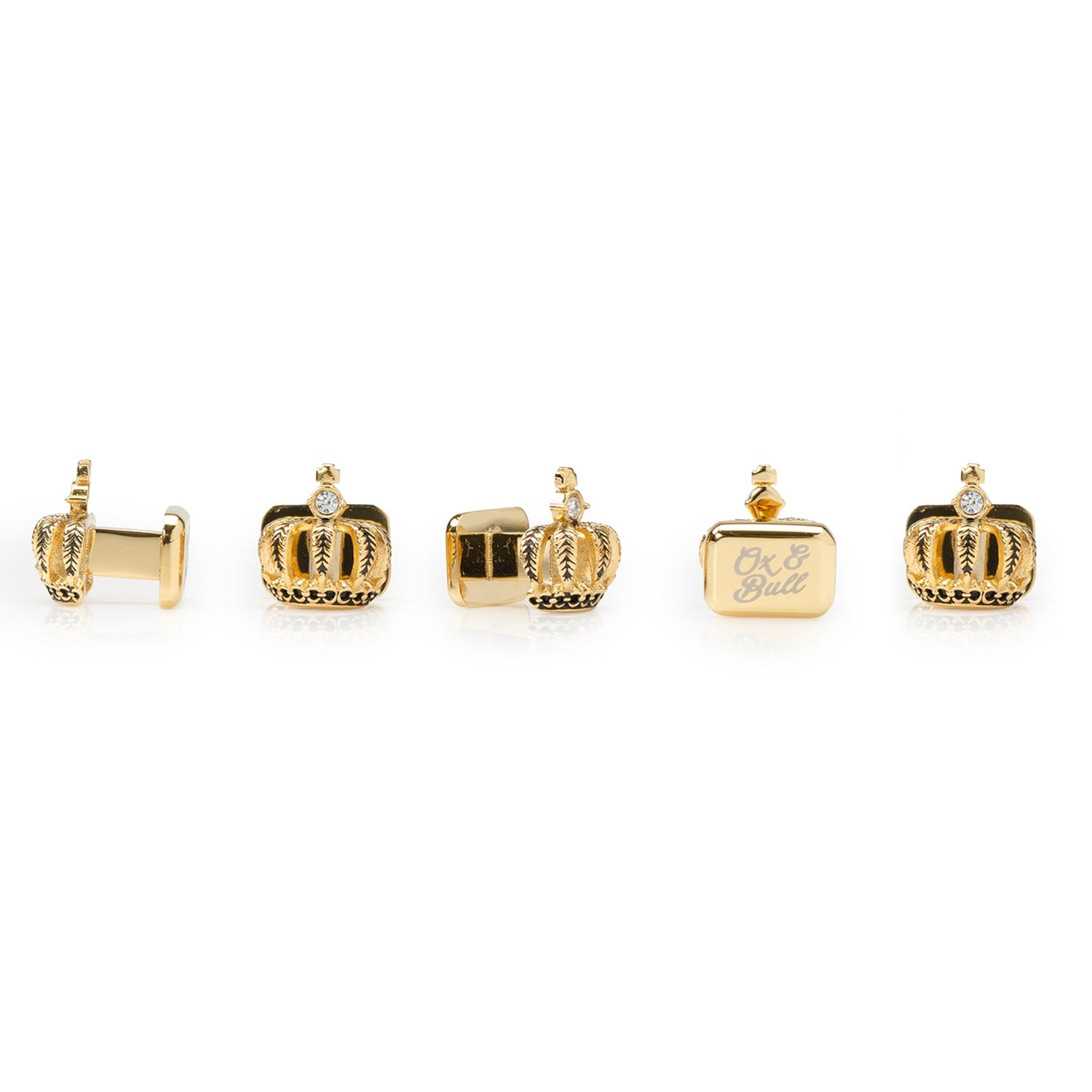 Set of gold crown-shaped cufflinks on a white background