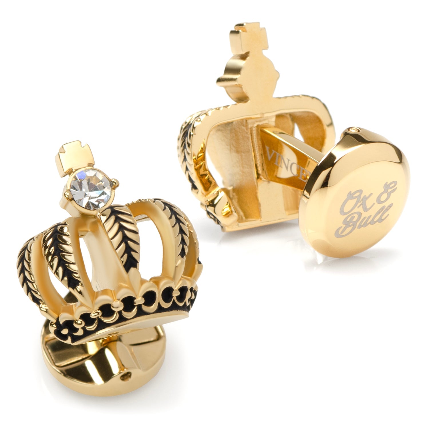 Gold crown-shaped cufflinks with a gemstone on a white background