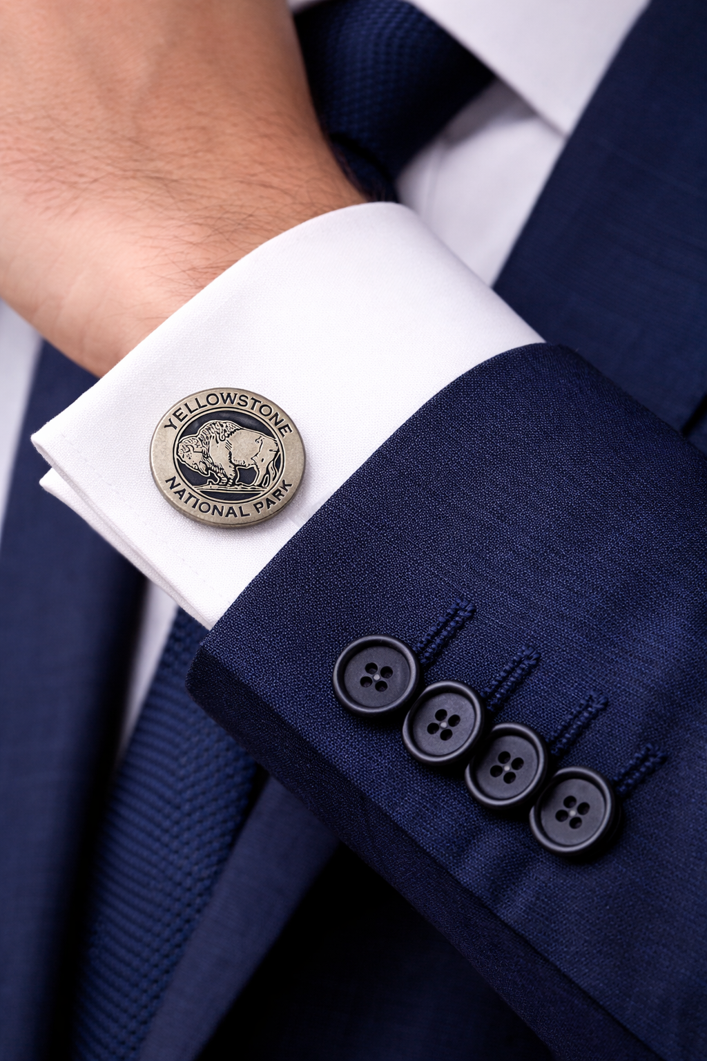 Cufflink with Yellowstone National Park logo on a suit cuff