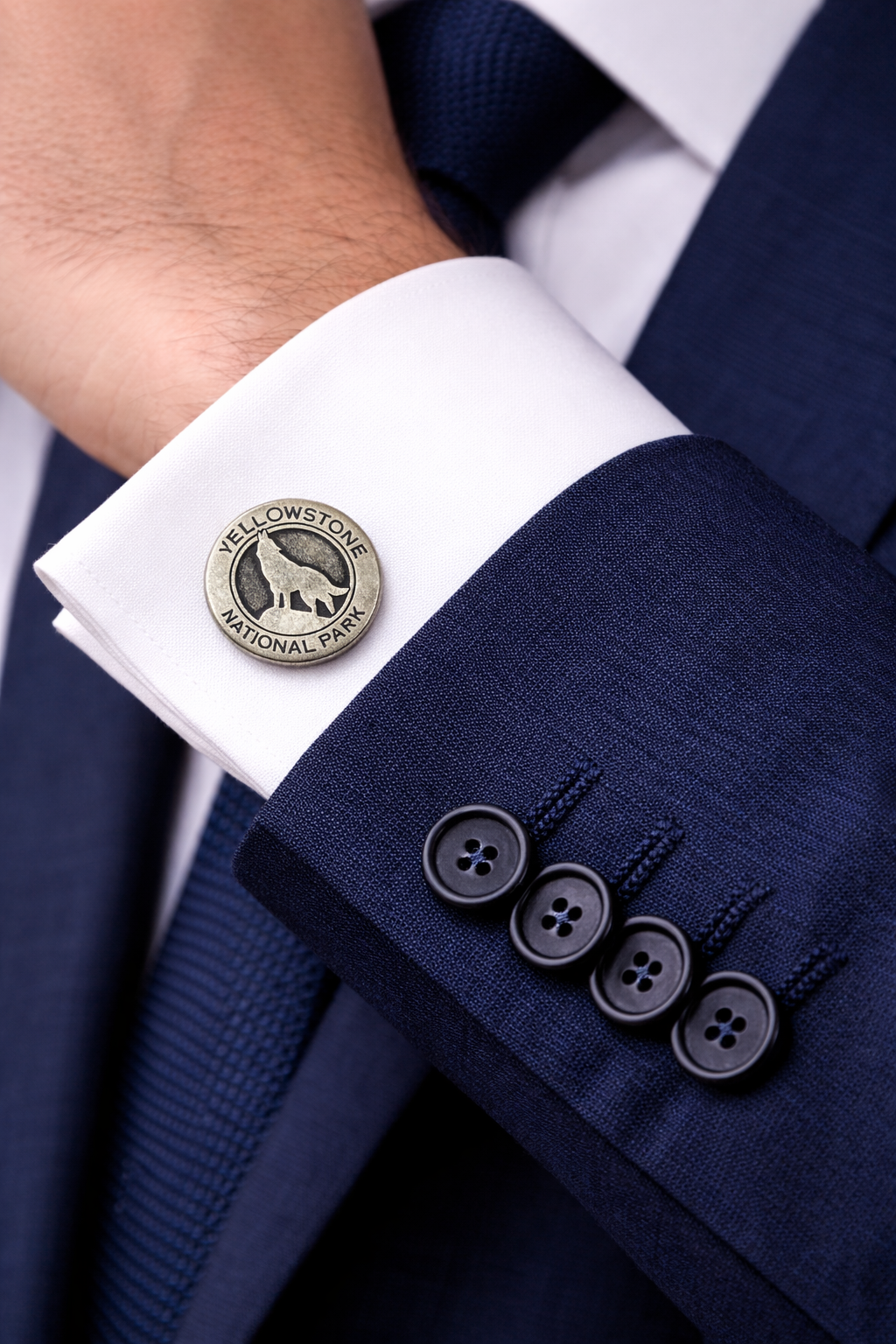 Navy suit with white shirt and cufflinks featuring Yellowstone National Park design.