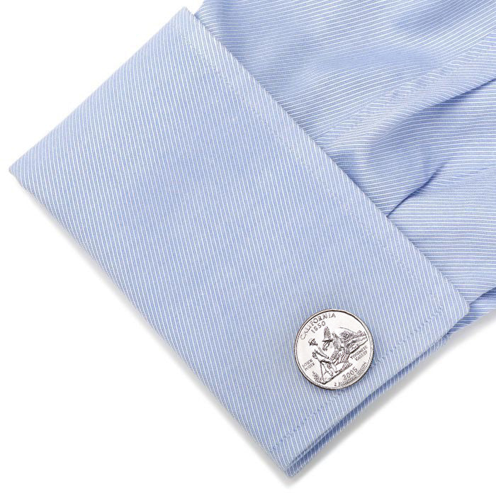 Silver cufflink on a light blue shirt cuff