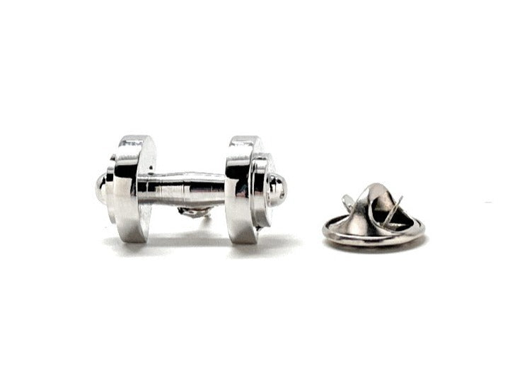 A silver dumbbell-shaped lapel pin with a reflective metal finish, displayed against a white background