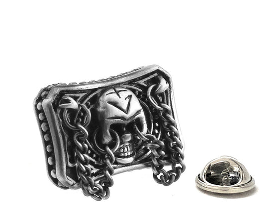 Silver skull and chain design lapel pin on a white background