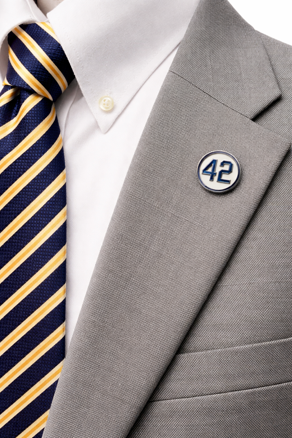 Number 42 enamel lapel pin worn on a gray suit jacket with striped tie
