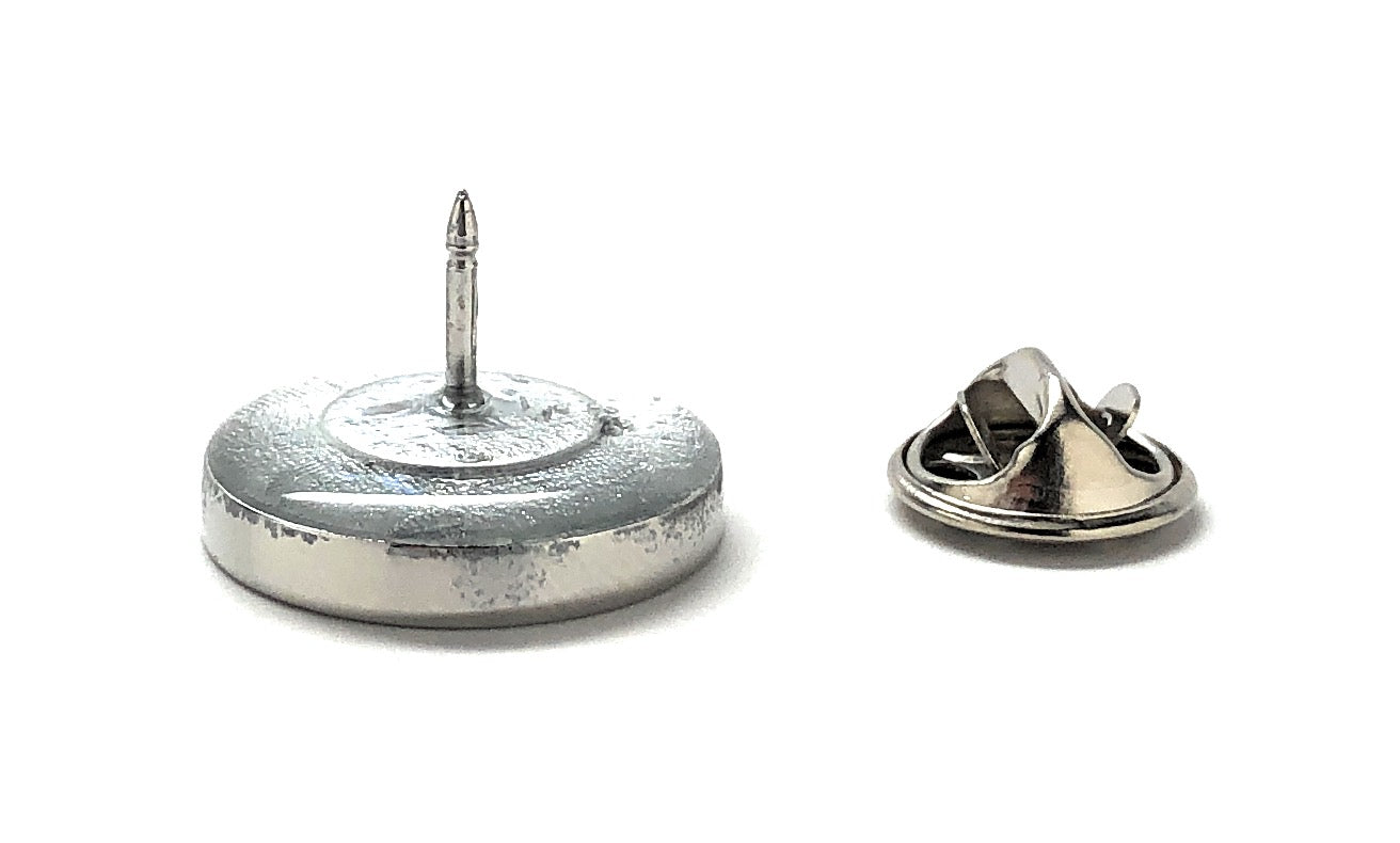 Metallic badge with a pin on a white background