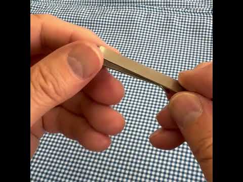 Silver maple leaf tie bar shown on red and gold striped tie — elegant accessory inspired by Canada, handmade by JayPins.