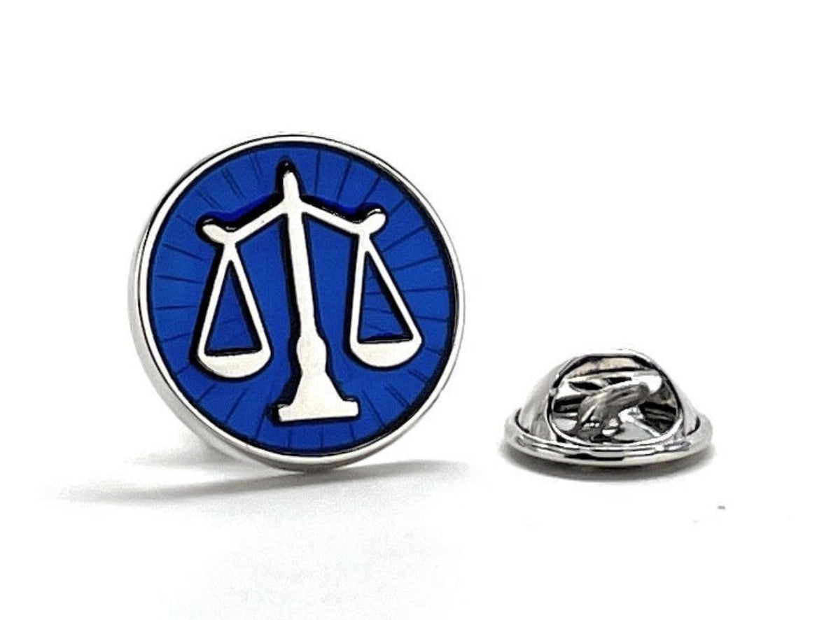 blue and silver scale of justice lapel pin with white background
