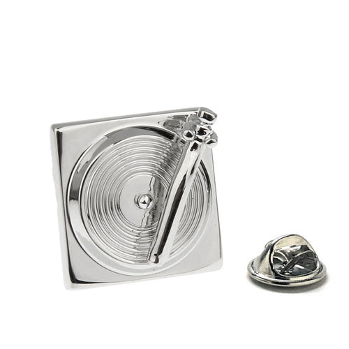 Silver geometric lapel pin on a white background
