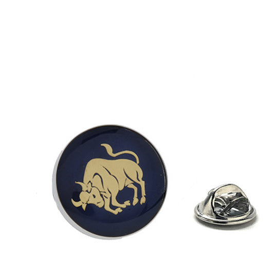 Gold bull Taurus zodiac lapel pin on navy blue background with butterfly clasp backing